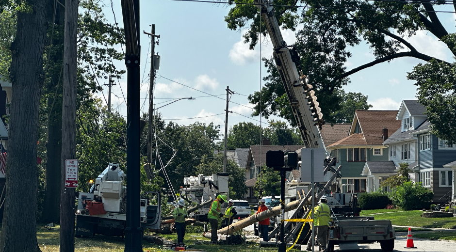 Line workers and trucks working on power lines