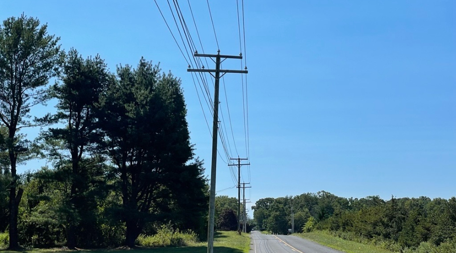 Line workers and trucks working on power lines