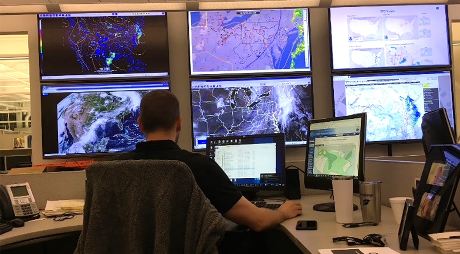 FirstEnergy meteorologist monitor the weater on several large screens.