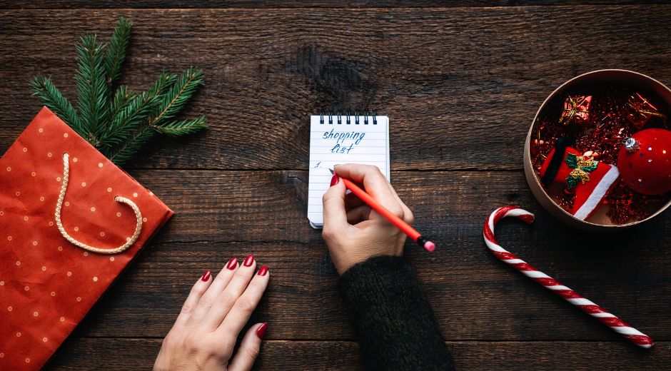 Woman writing out a holiday shopping list